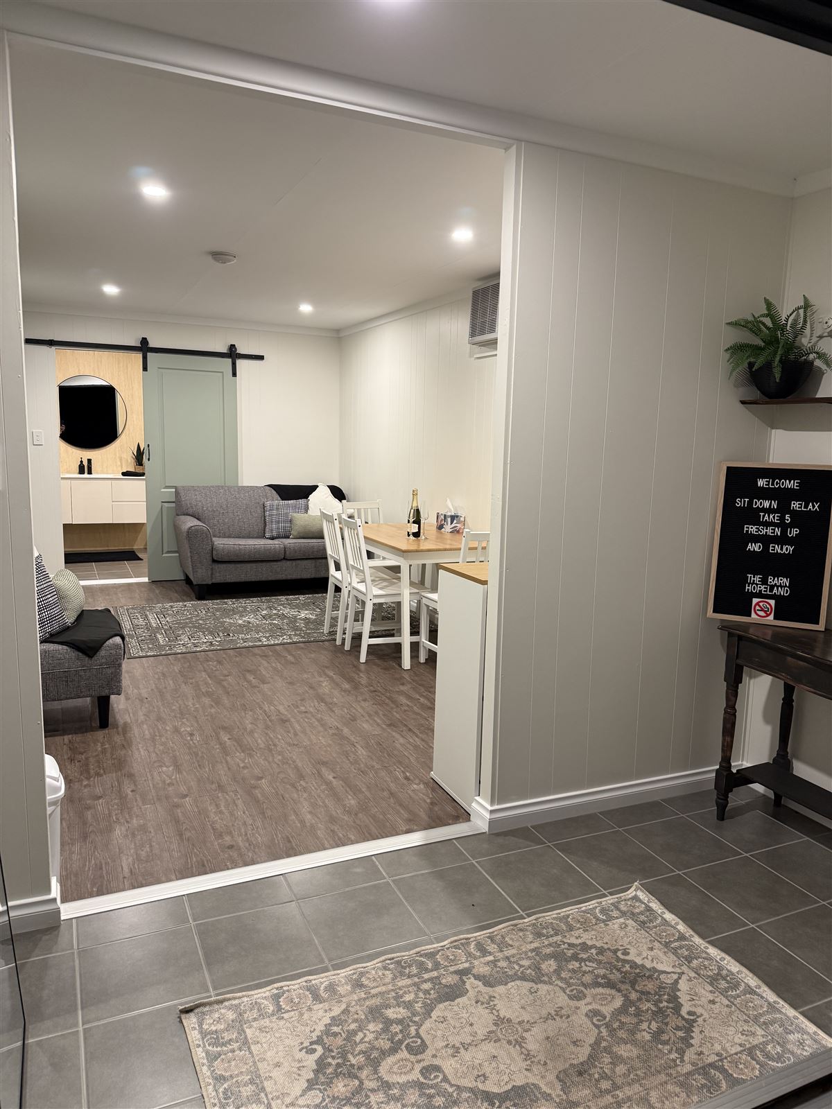 Bridal suite lounge with couch, dining table and welcome sign